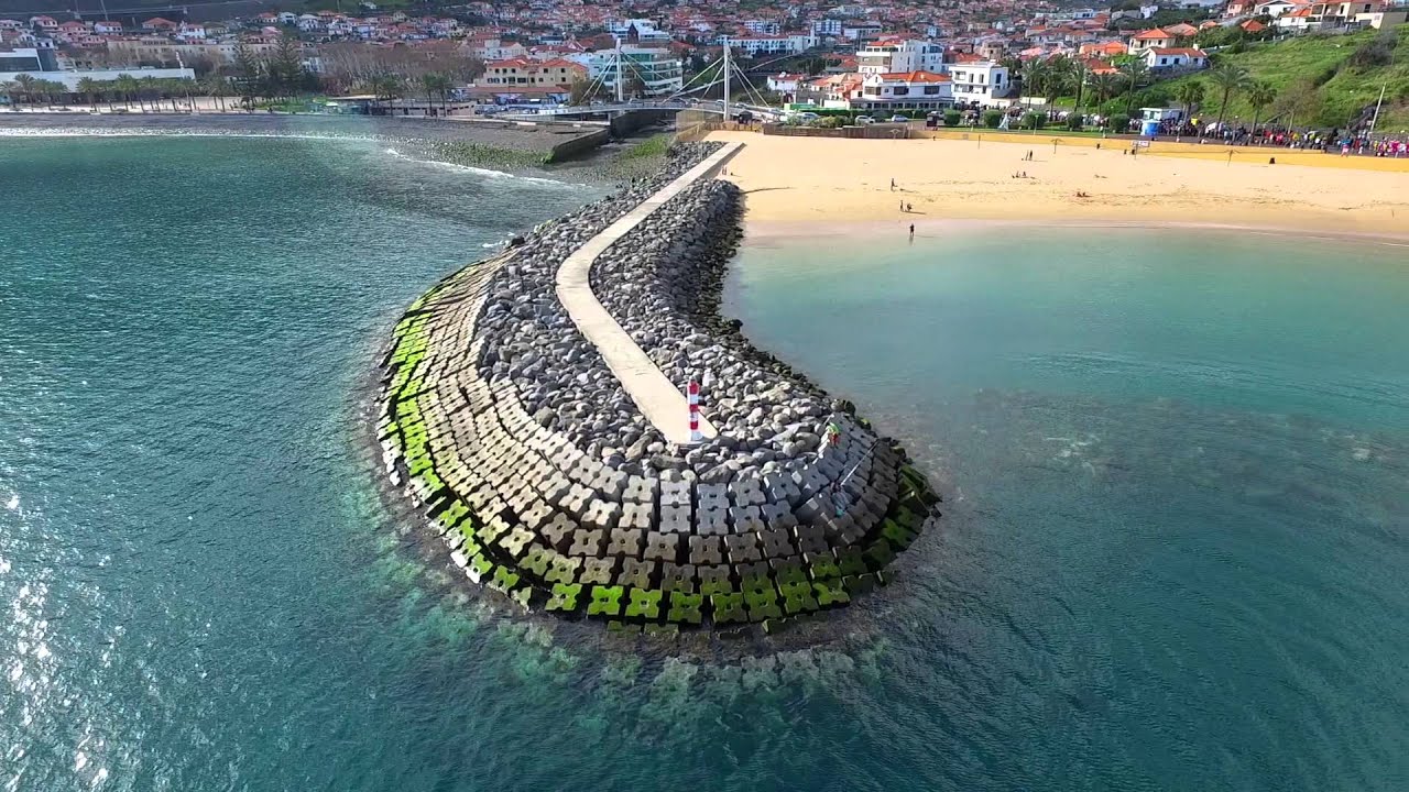 Experience the aerial panoramas of Machico Beach.