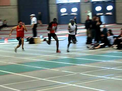 Dorcelus winning his heat in 60m dash