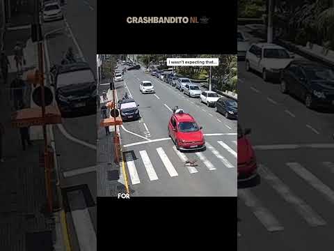 Motorcycle Crashes into Car in Busy Street
