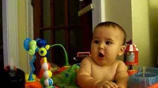 Noah eating cheerios and drinking from a straw