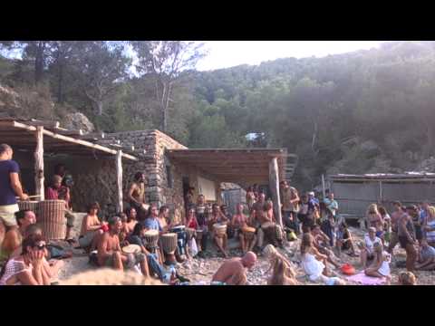 Sunset in Cala Benirras, Ibiza, with Hippies playing drums