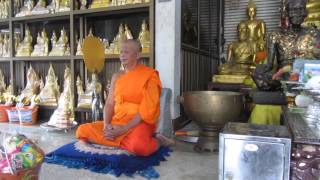Thai Buddhist Monk Chanting in a temple near Bang Len , Thailand