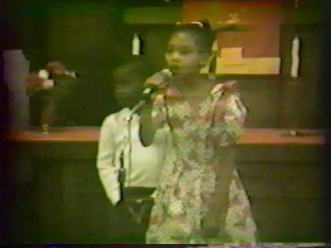 Jamela Bullock sings at church in 1989 with her brother