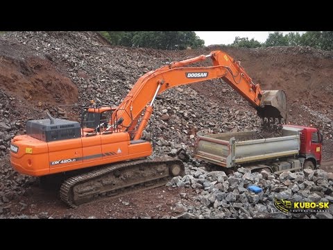 Doosan dx420lc excavator loading volvo fm 6x6