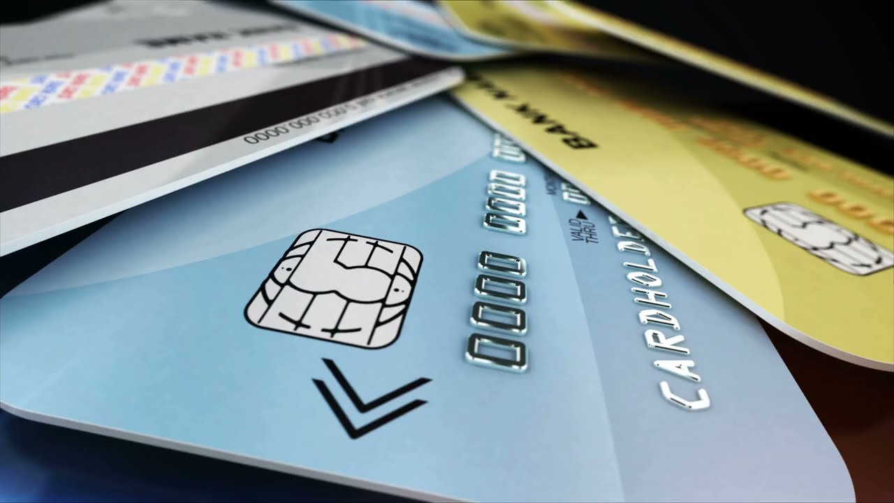 A Few Color Credit Cards Rotate on a Glossy Black Background Closeup Shot with Dept