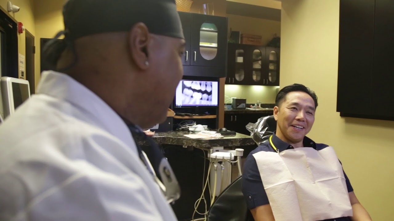 Man in dental chair talking to his dentist in Louetta