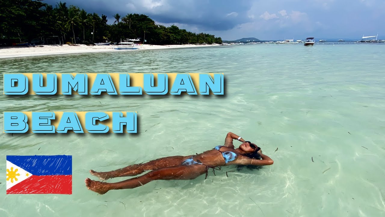 Experience the serenity at Dumaluan Beach through the lens of a tourist.