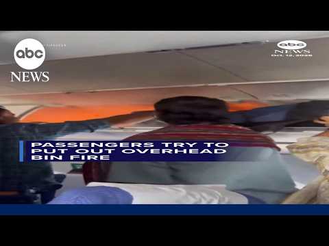 Passengers try to put out overhead bin fire