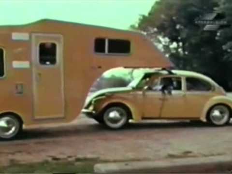 VW Beetle pulling a travel trailer
