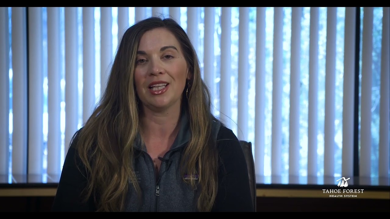 Karli Epstein, Executive Director of IVCH and TFHS Foundations, sitting in front of a window