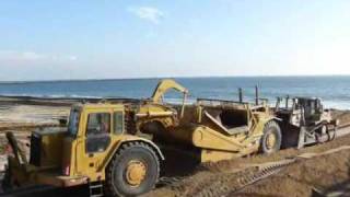 D8R push loading 637E’s at the beach