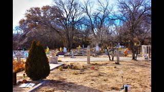 Dusty old cemetery in the desert with statues, monuments, &amp; flowers. Part 1