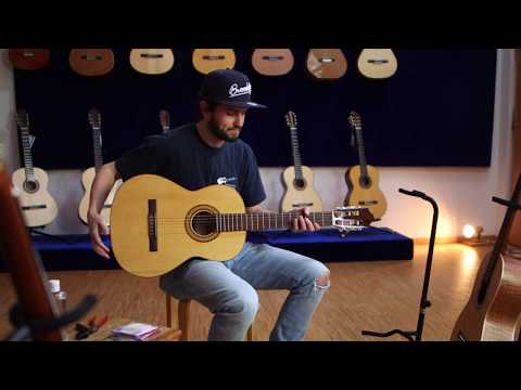 Instructions for stringing a classical guitar with a single hole