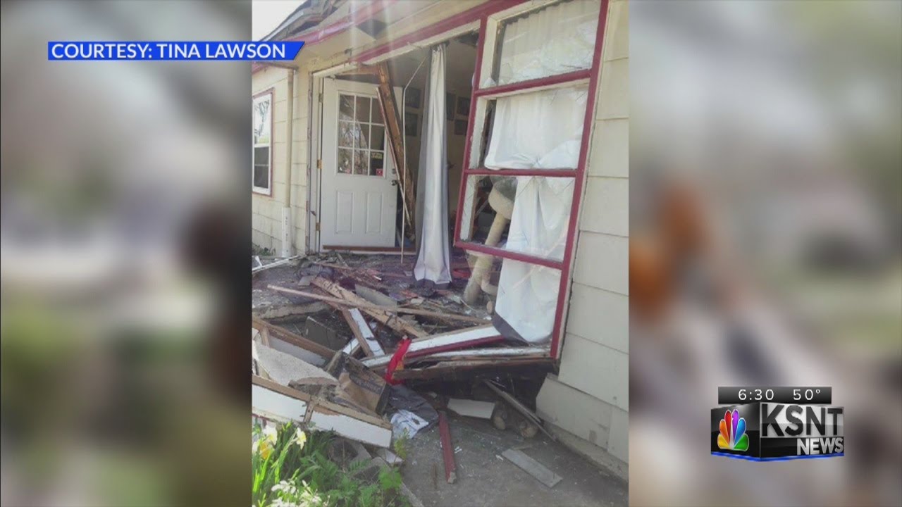 Backhoe crashes into house