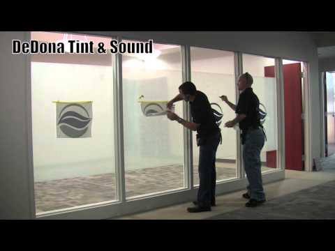 Installing decorative window film and company logos.