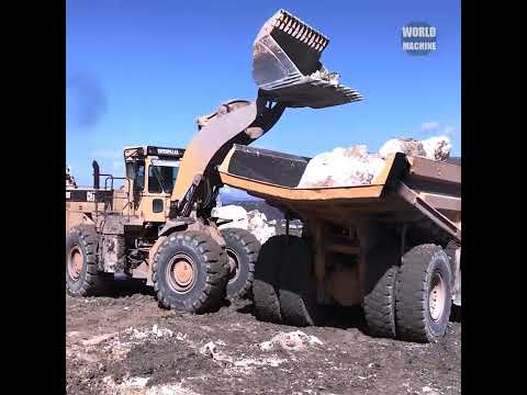 Caterpillar 988F Wheel Loader Loading Komatsu Dumpers With Stones.