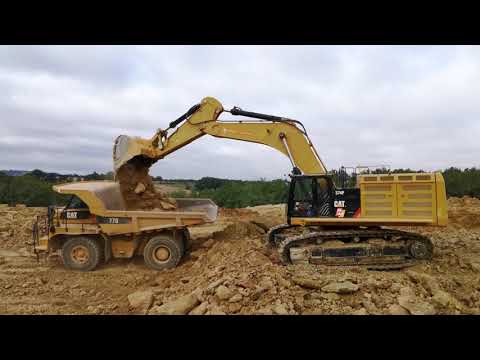 Caterpillar 374F loading 769C, 770 and 740