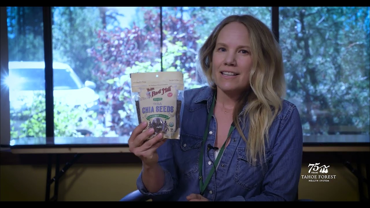 Lisa Fligor, Wellness Dietitian at Tahoe Forest Health System, holding a bag of chia seeds while sitting in front of a window
