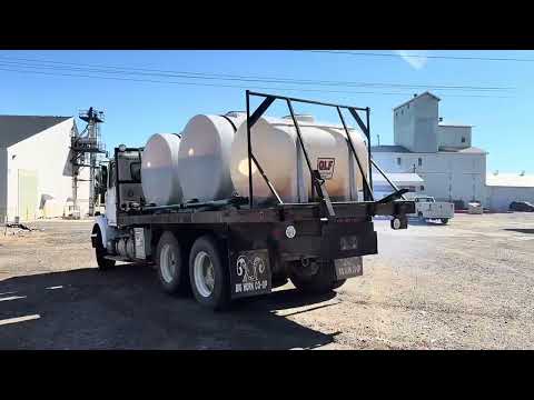 1986 White Flatbed Truck w/ (2) 925 Gallon Fertilizer Tanks and (1) 535 Gallon Fertilizer Tank