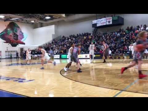 Grand Haven's Casey Constant pump fakes and knocks down a 3-pointer against Spring Lake
