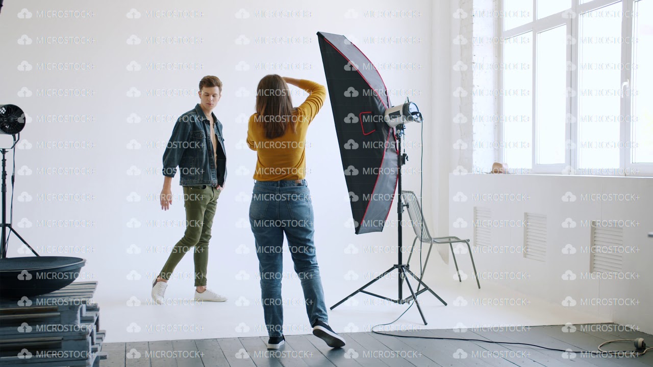 Good-looking man posing for photo camera in studio advertising trendy clothes