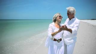 Happy retired couple on beach