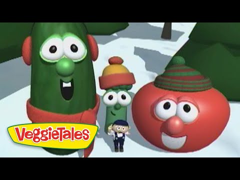 Three VeggieTales characters—a tall cucumber, a small green bean, and a red tomato with hats—pose in a snowy scene with a tiny man in front and the VeggieTales logo.