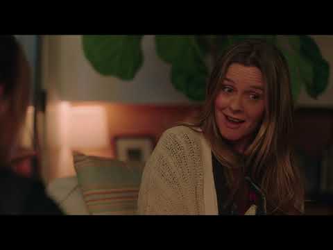 Trailer shot of Julie and Randy framed against neon signs as a power ballad rises