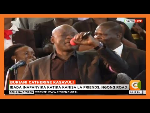 Tom Mboya leads colleagues to sing for Catherine Kasavuli during her memorial service