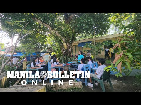 Students attend classes outside their classrooms in Albay