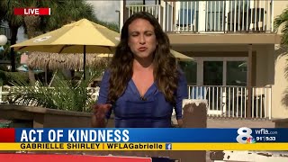 Justin Johnson and Renal Roberts helping to carry a girl to a blanket on St. Pete Beach