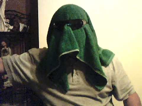 mystery tea towel man on a hot sunny beach