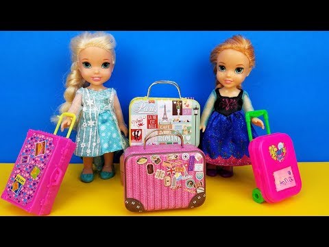 Elsa and Anna toddlers - shopping for luggage - suitcases - Barbie is the seller