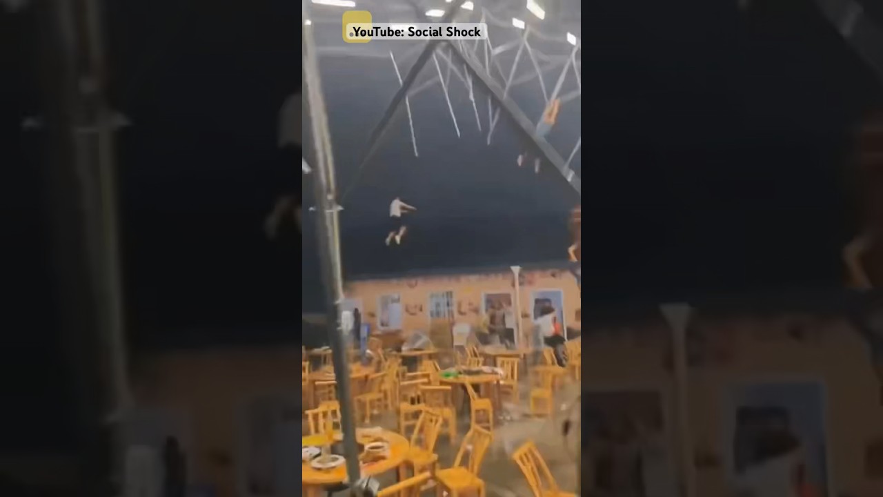 Strong Tornado Winds Blow Away People Trying to Keep Tent from Blowing Away