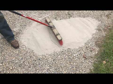 Part of a video titled brushing CHEAP concrete onto a gravel driveway (adding strength ...
