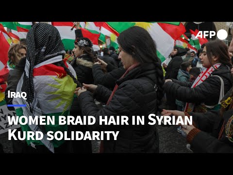 Iraqi Kurdish women braid hair at protest in solidarity with Syrian Kurds | AFP