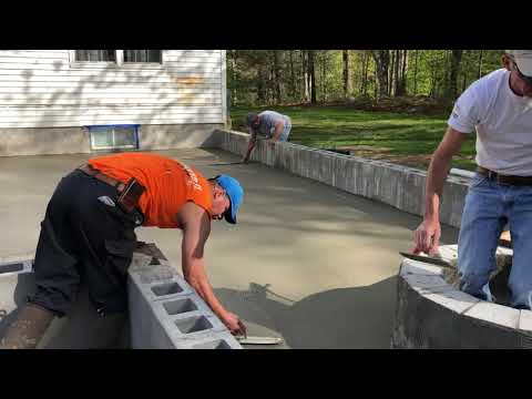 Basement Systems of New York Installing A New Concrete Patio Slab with a Retaining Wall and Stairs