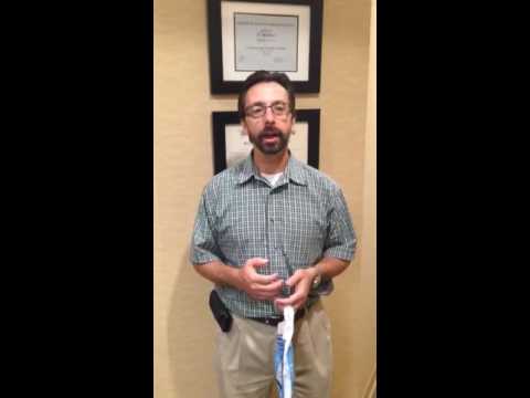 Man in short sleeved button up shirt standing in dental office