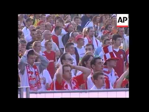 Polish and Ecuadorean fans follow the match on giant screen