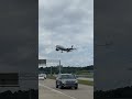 Delta Airlines Plane Flying Low Over Vehicles