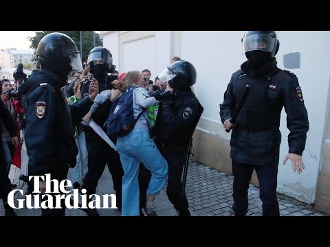 Riot police in Russia punch a women in stomach during a protest for free elections