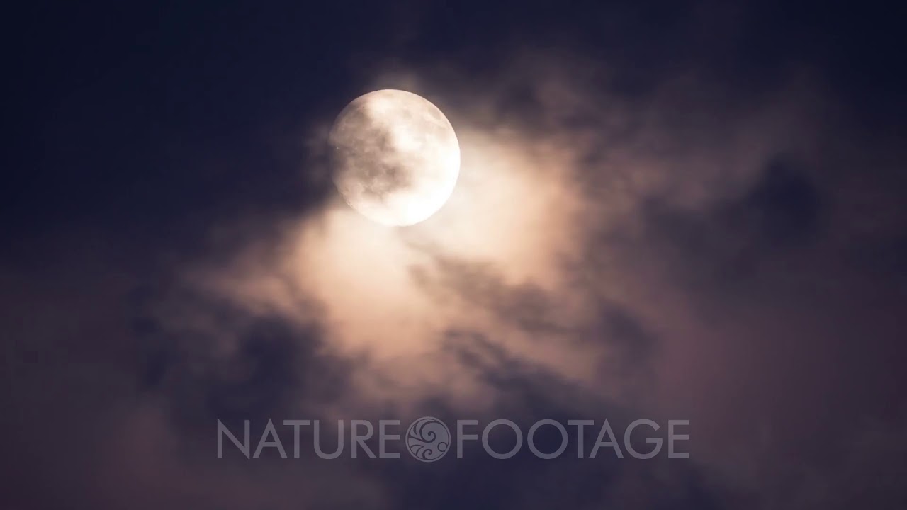 bright full moon behind moving clouds timelapse