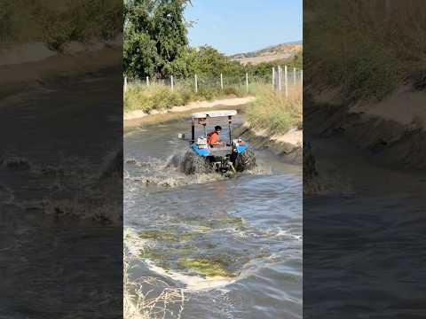 Tractor Cleaning the Water Channel