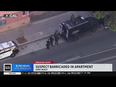 Armed suspect barricaded inside apartment in Long Beach
