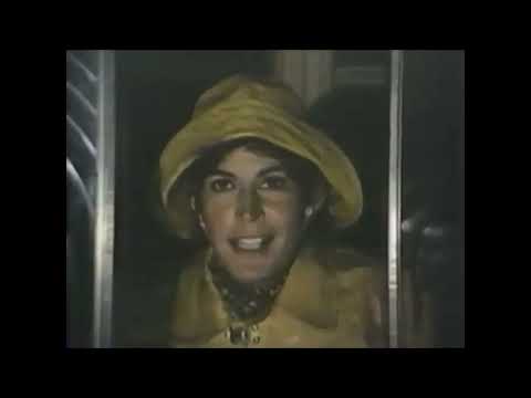 1977 Pete’s Dragon theatrical trailer frame: lighthouse balcony above stormy seas as music swells toward 'Candle on the Water'