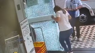 Woman Shatters Store's Glass Door While Pushing it Open