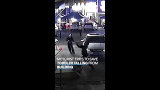 Man attempts to catch toddler falling from second floor of a building
