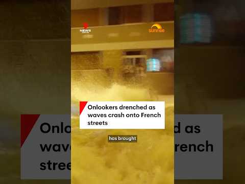 Onlookers drenched as waves crash onto French streets