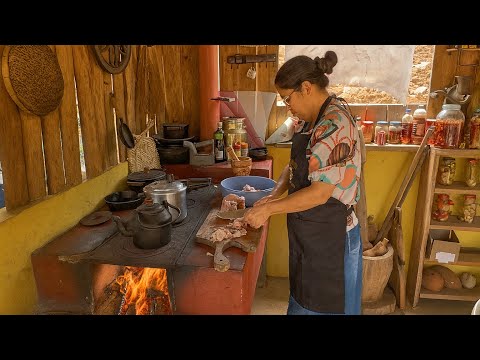 WOOD STOVE BURNING AND GOOD FOOD, A COUNTRY LUNCH WITH THE FAMILY GATHERED IN THE COUNTRYSIDE.