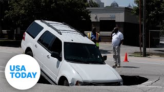 Large sinkhole swallows an SUV, stopping traffic in Atlanta, GA | USA TODAY